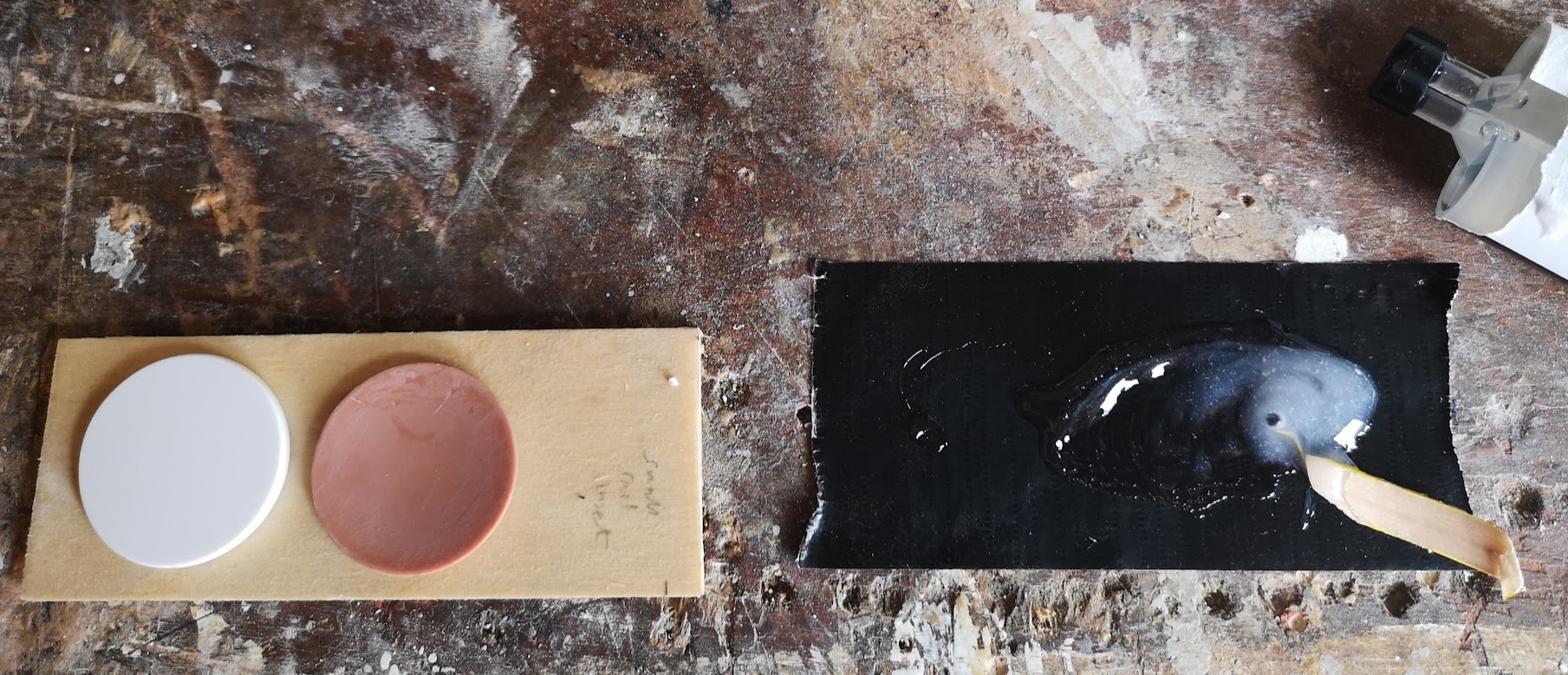 Bonding the new white button to the brown button with epoxy